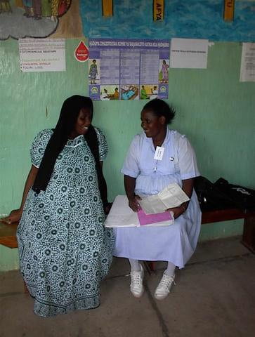 Trainee interviewing antenatal care client in Tanzania