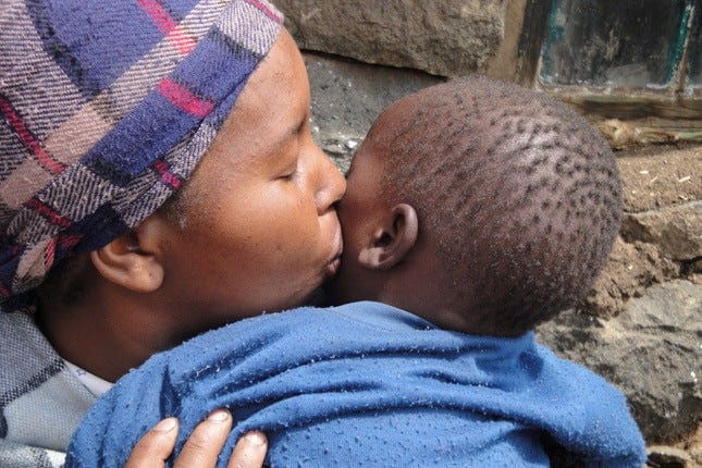 Mother kissing baby; Photo Credit: USAID Africa