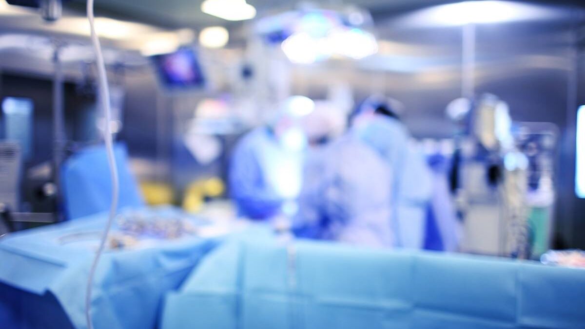 Surgeons work in an operating room.