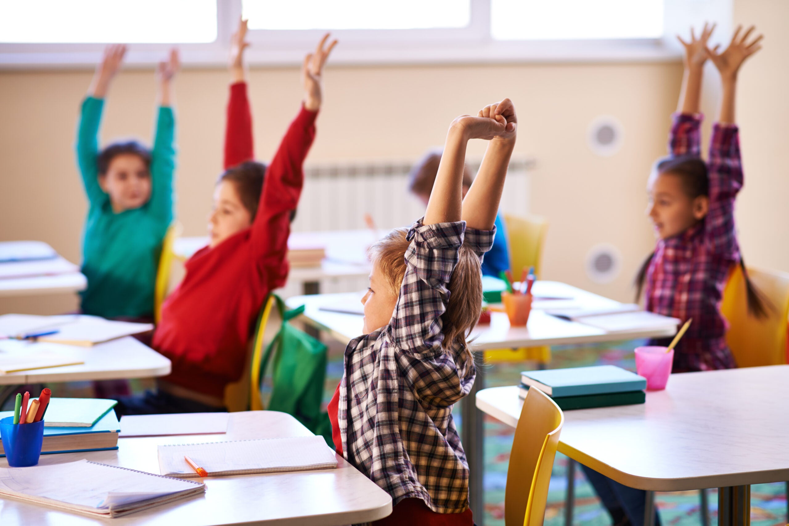 School children participating in a movement break in the classroom