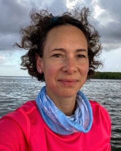 Natasha Gilbert headshot, photographed near the ocean.