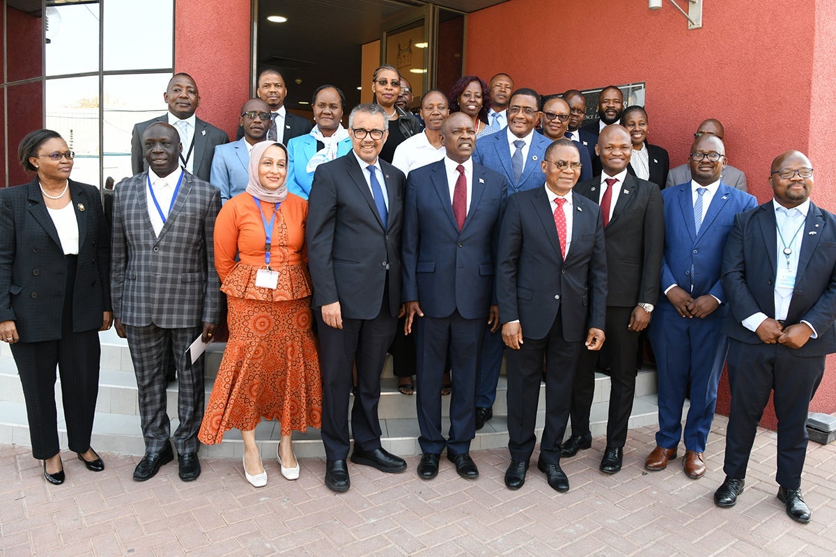 High-level visit: World Health Organization Director-General Tedros Ghebreyesus (first row, fourth from left) and Botswana President Mokgweetsi Eric Keabetswe Masisi (first row, fifth from left) with members of the Botswana Harvard Partnership lab