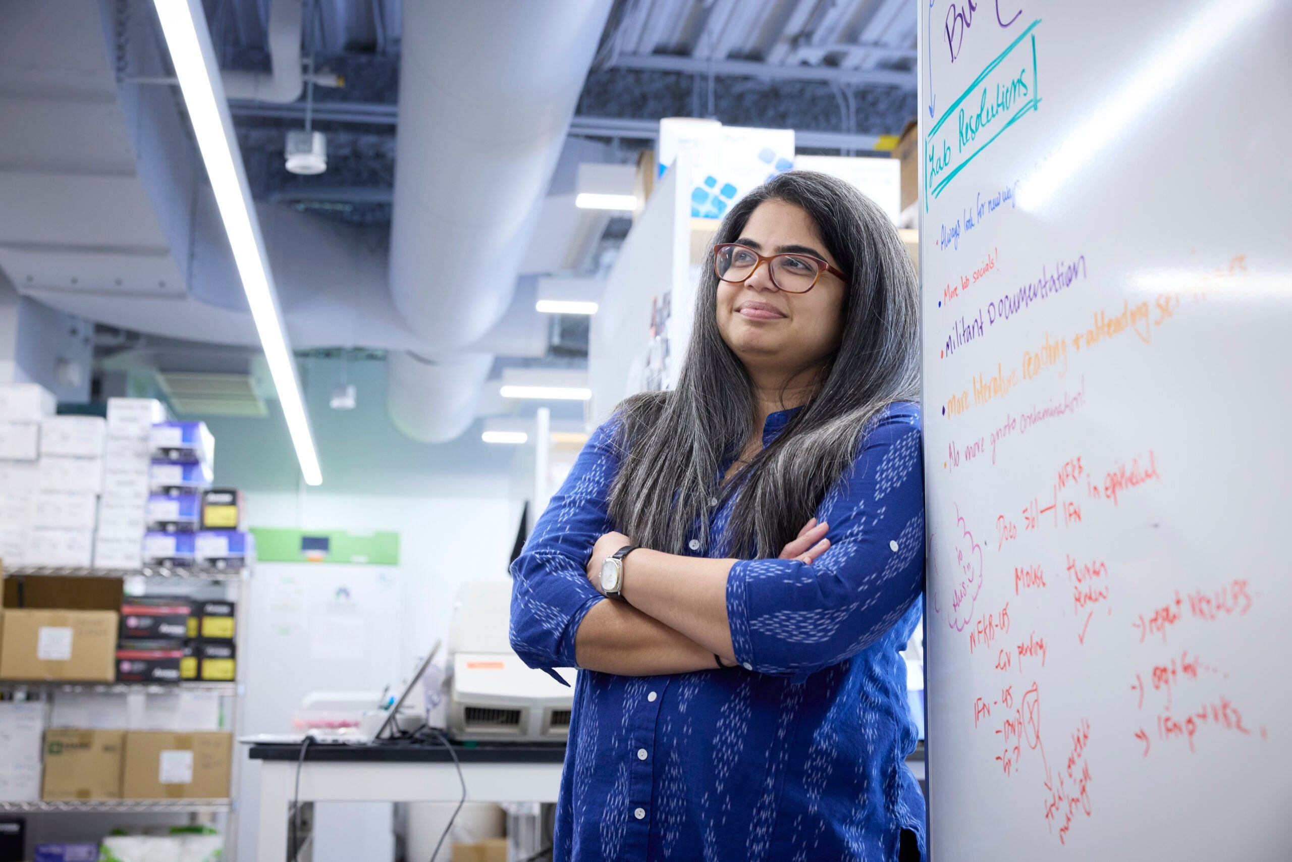 Smita Gopinath standing by the board, in her lab