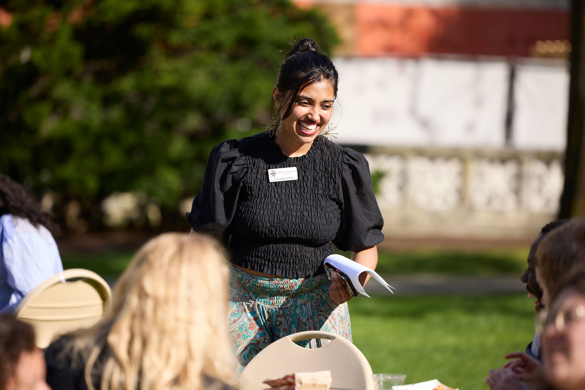 a student council member talks to a group of people outside