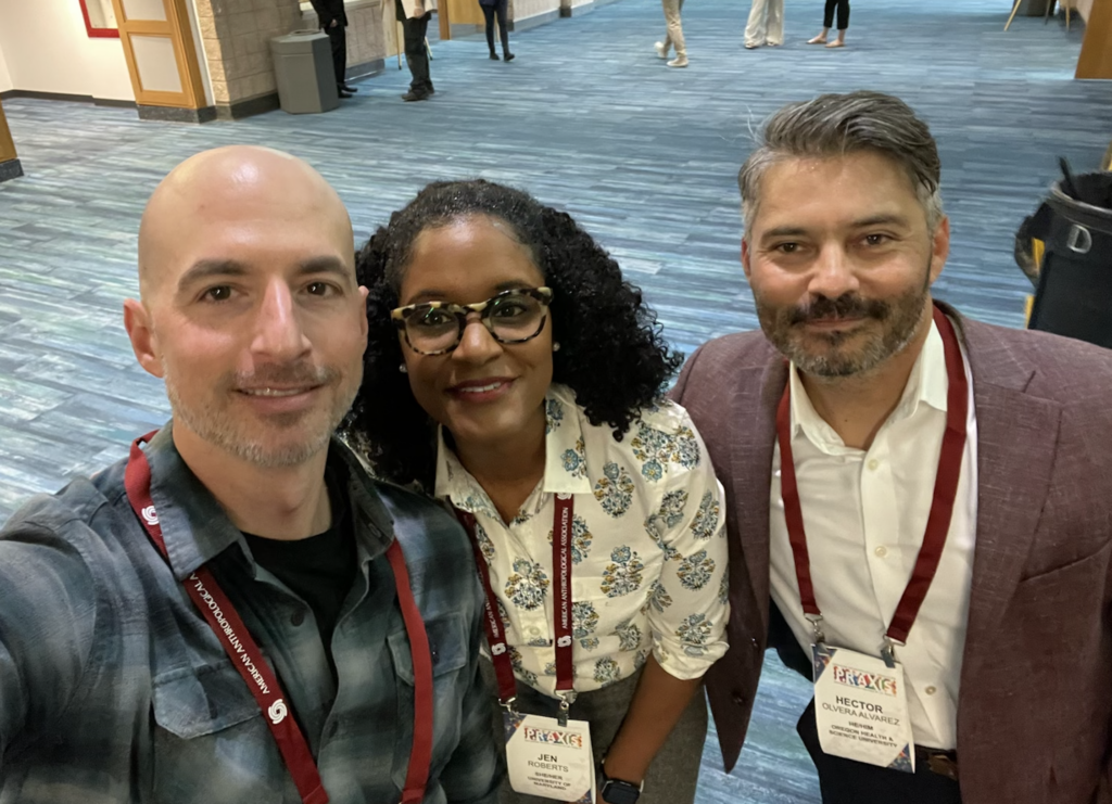 Fellows gathered at a conference, smiling and posing for a selfie