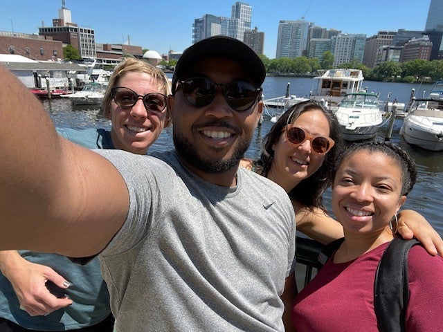 Fellows posing for a selfie during a boat tour on the Charles River in Boston