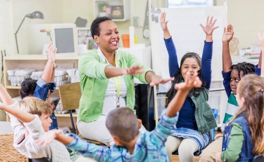 A teacher leading a movement break in a school classroom