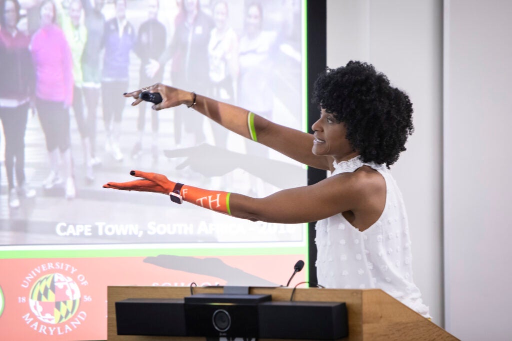 A Fellow pointing to something on a screen while presenting to other fellows during a workshop.