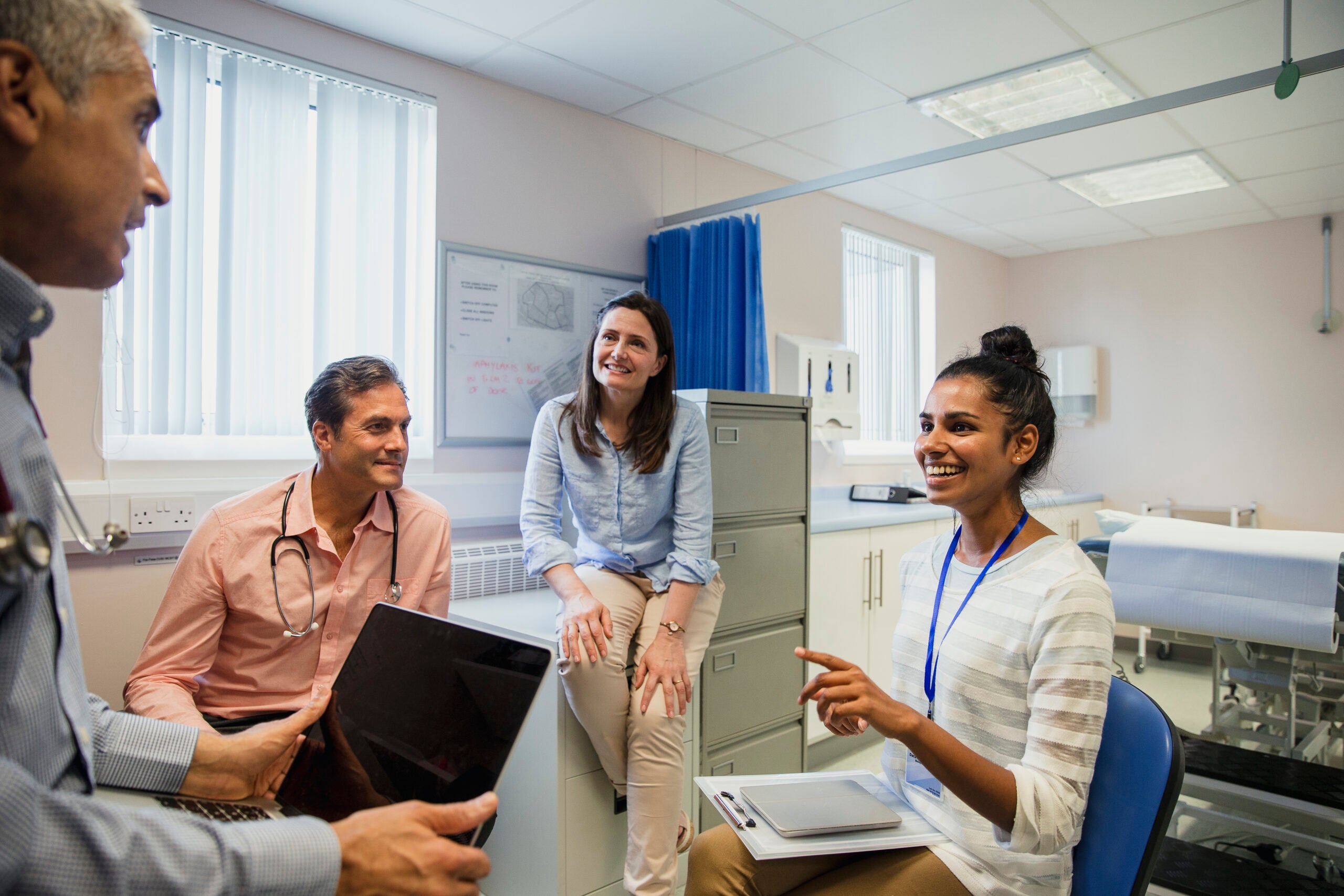 A group of mental health professionals sitting in a circle in a doctor's office talking