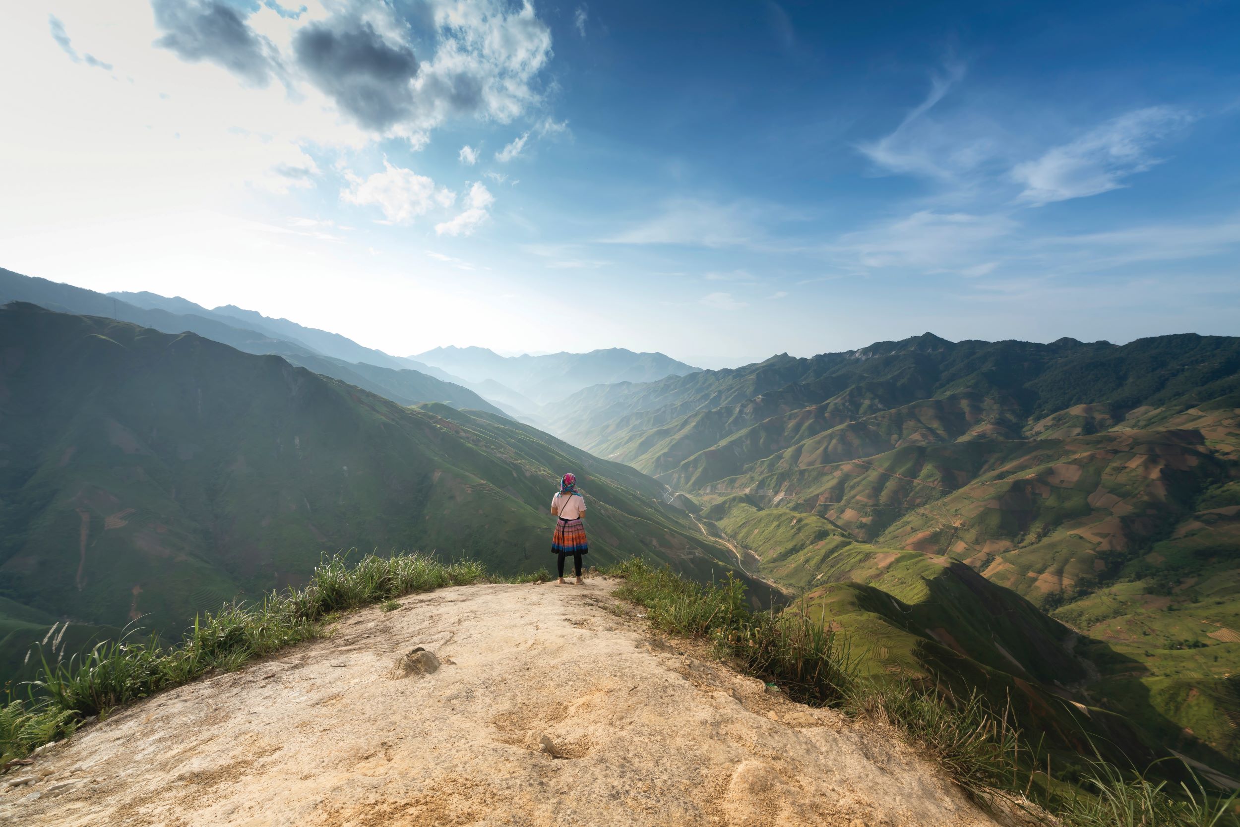 person standing on mountain summit