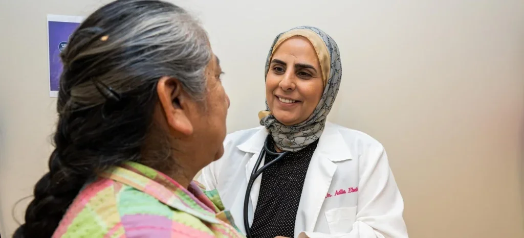 A doctor listens to a patients heart