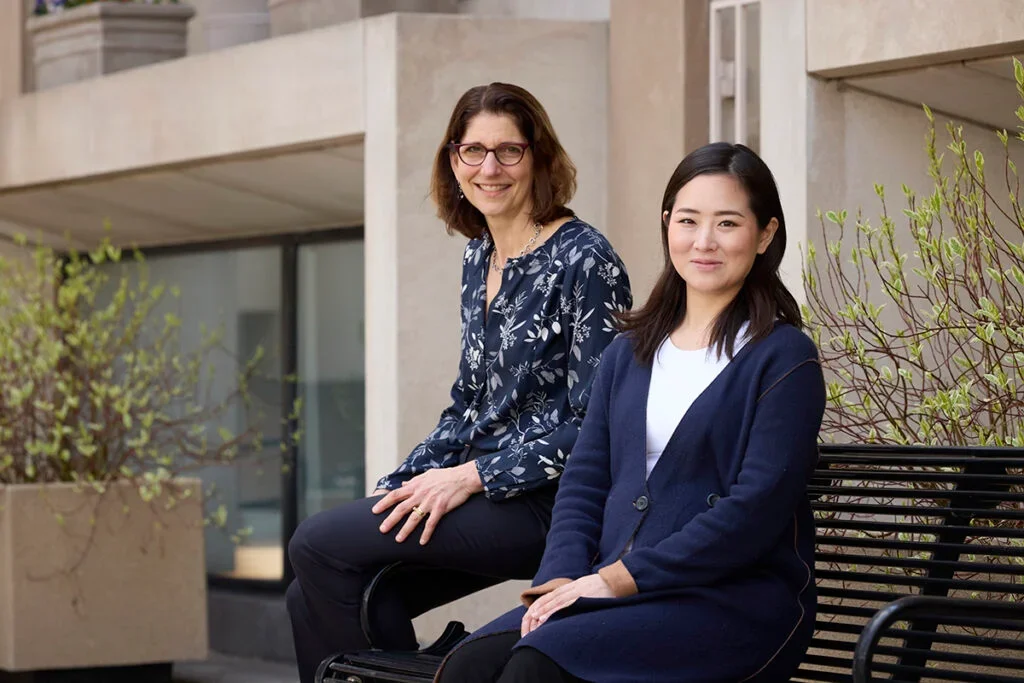 Dr. Kubzansky and Hayami Koga sitting on a bench