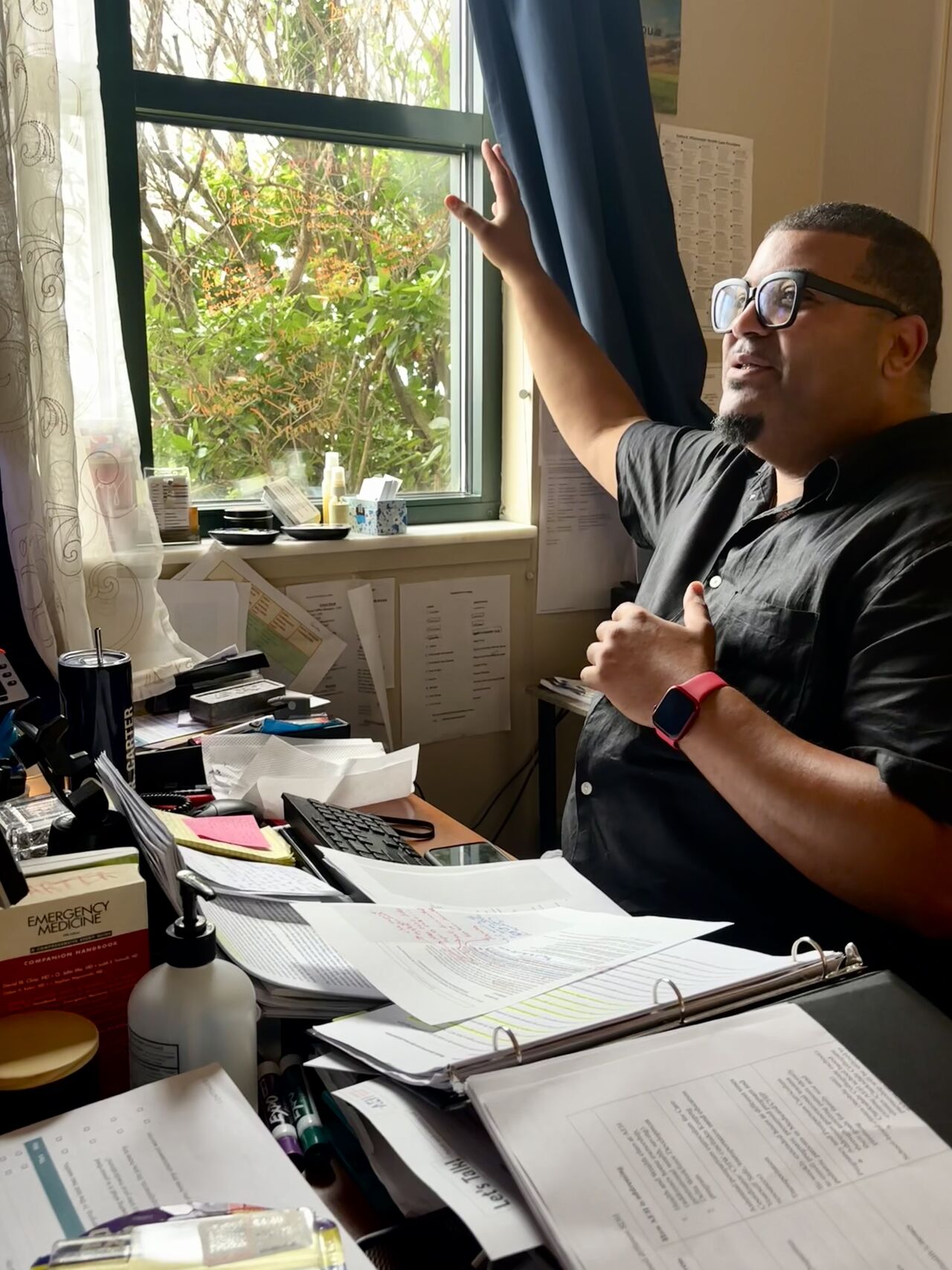 Will Carter behind a crowded desk