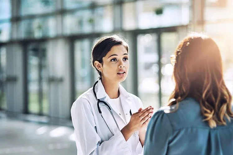 Woman physician having an earnest conversation outside with a patient