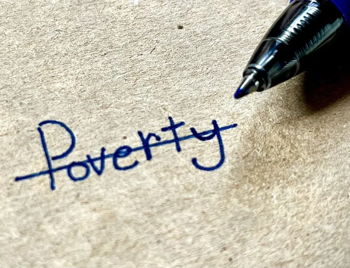 Word "Poverty" written and crossed out in pen.