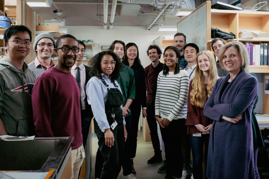 Sarah and her group posing for a photo in the lab