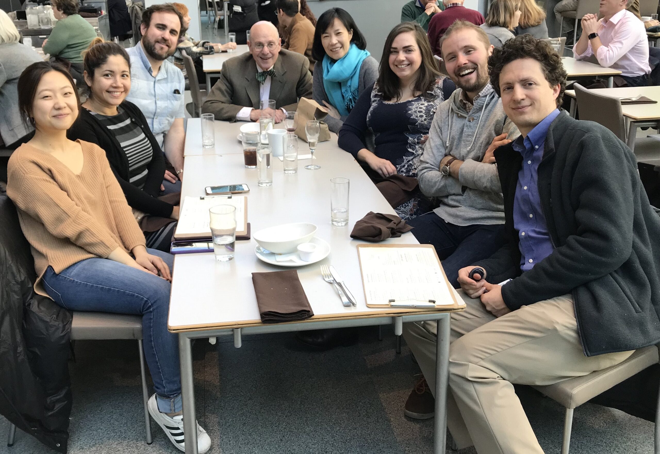 A group of people at a table at an outdoor restaurant.