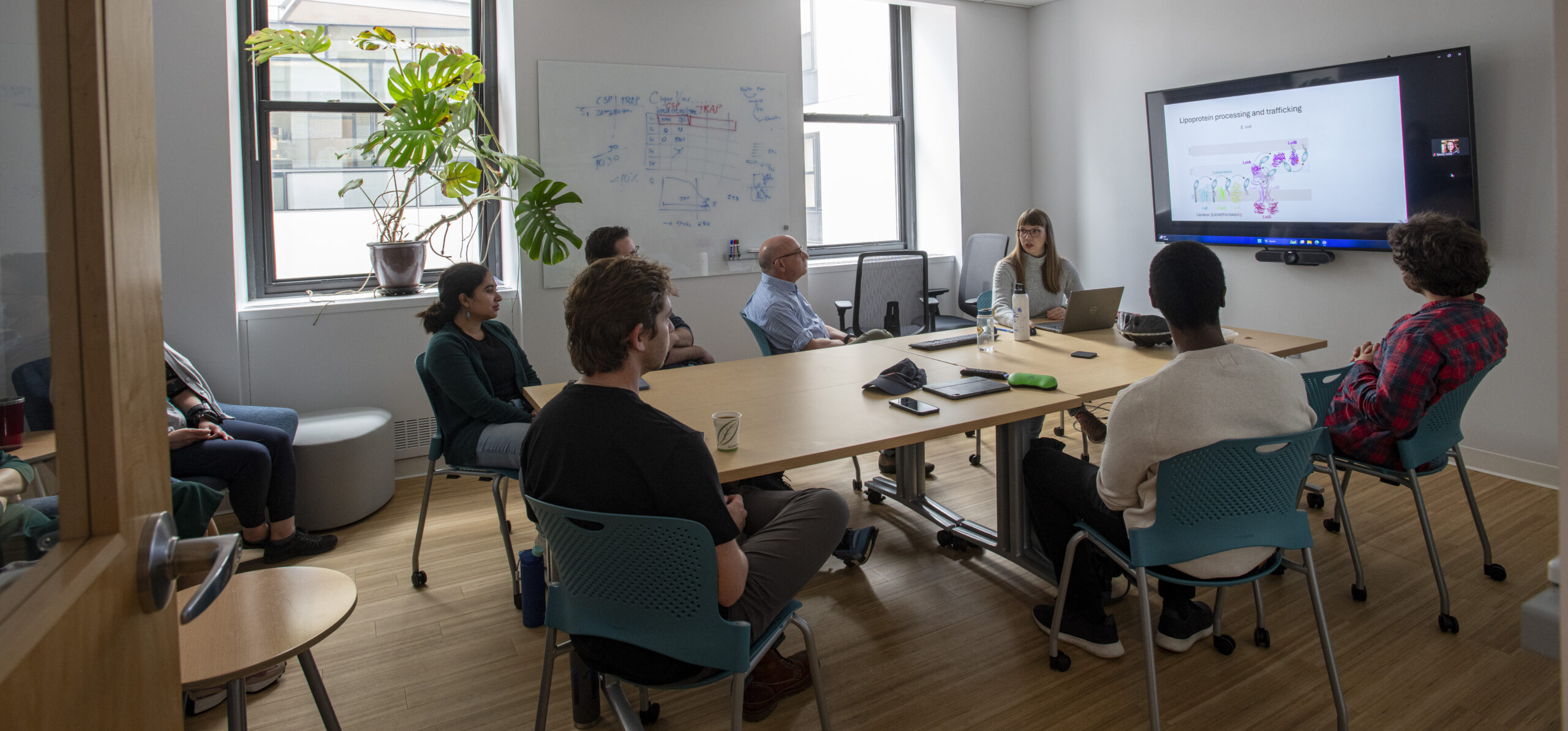 The Rubin lab listening to a member present during their lab meeting. 