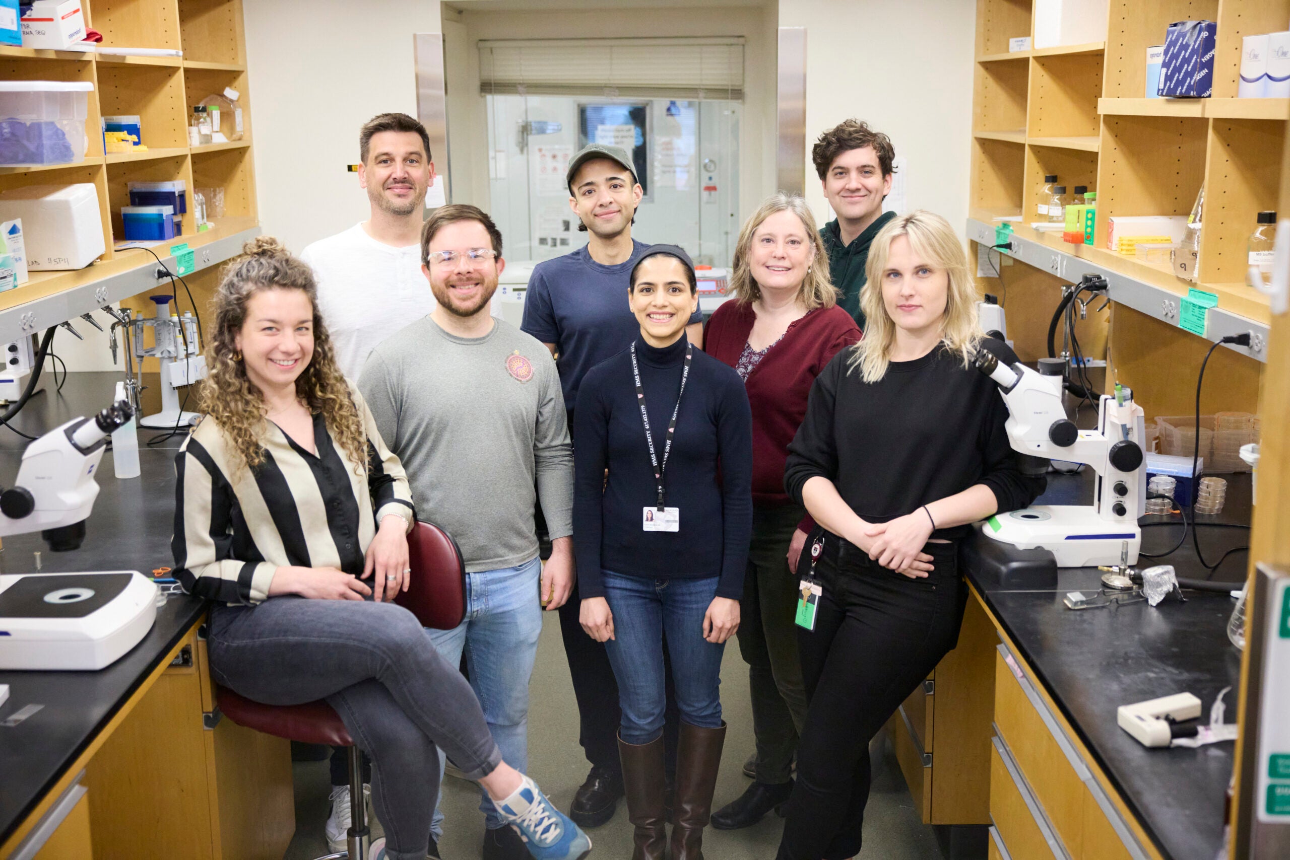 The Mair Lab posing for a picture in a basic science bay of their lab.