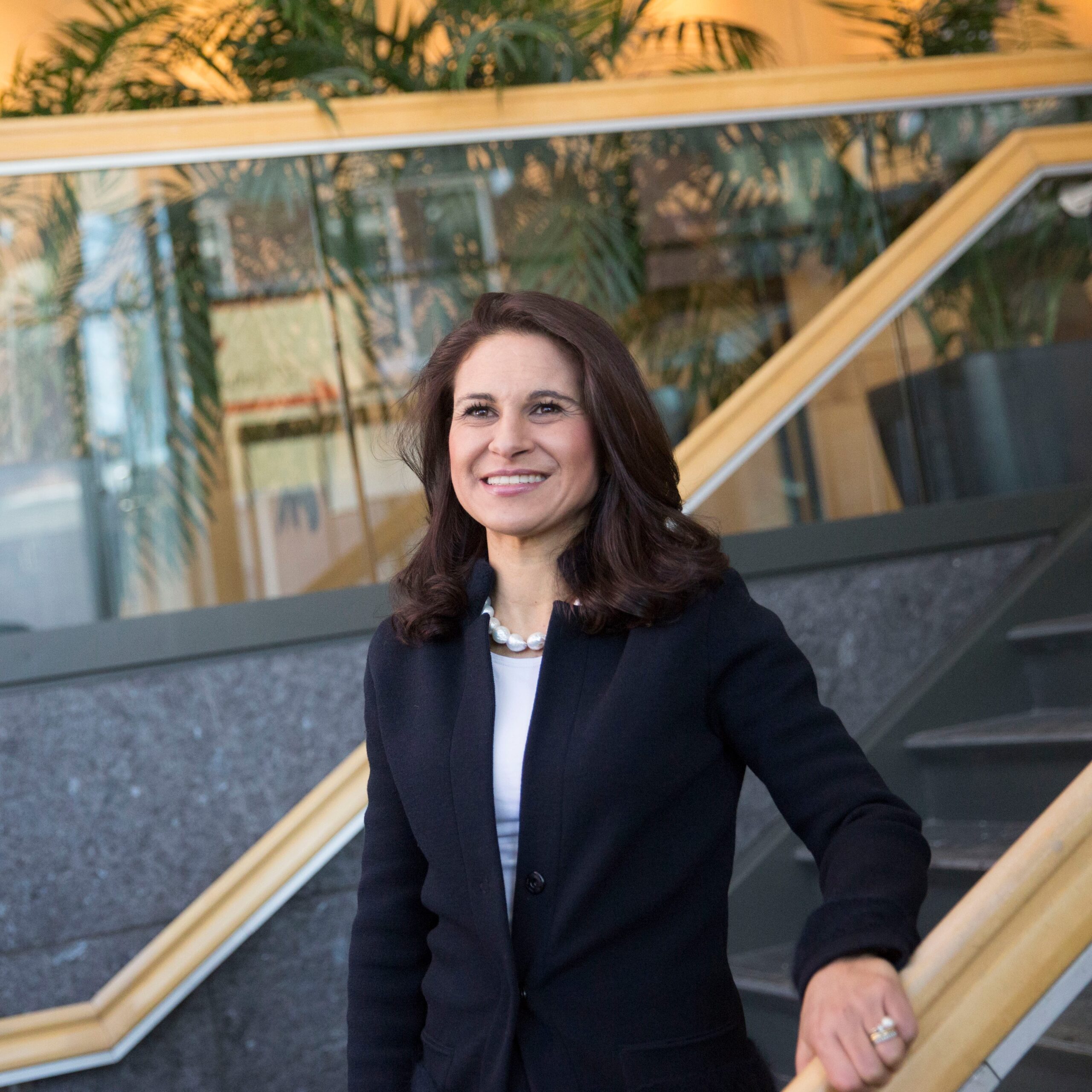 a headshot of Dr. Francesca Dominici. She is standing on a staircase with one hand on the banister.