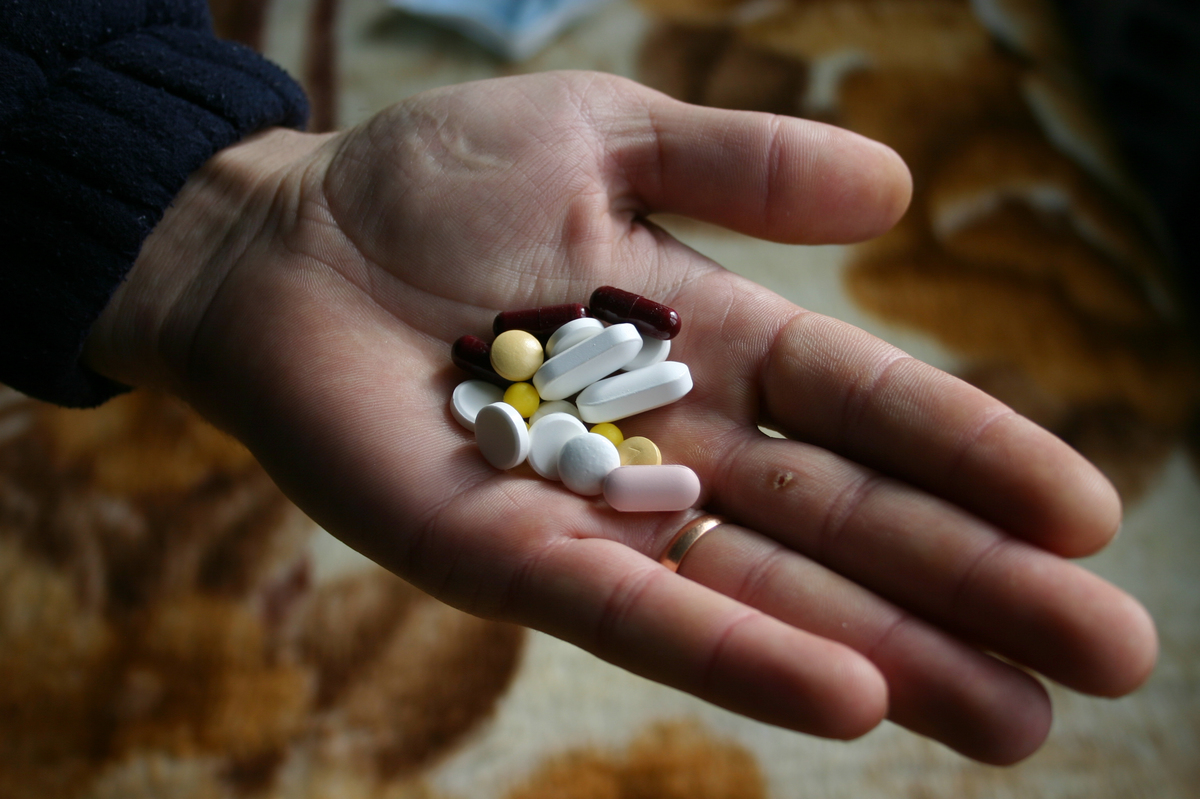 A handful of TB pills in the palm of a hand. 