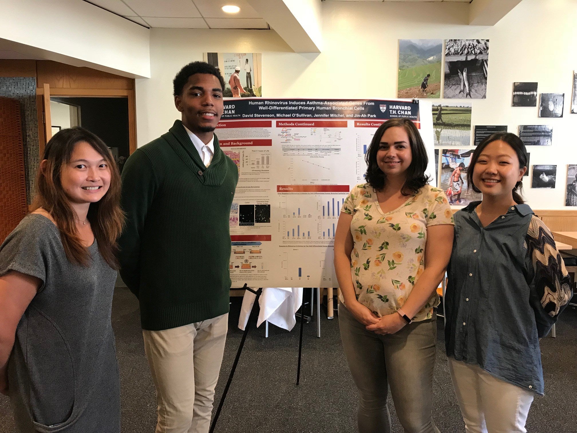 Four students standing in front of a research poster.