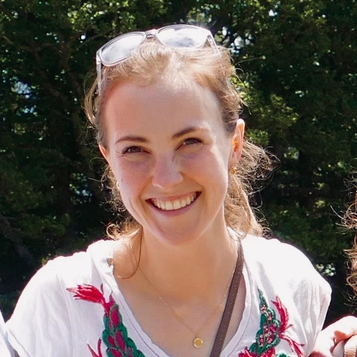 Headshot of Katie Westervelt in front of a nature background.