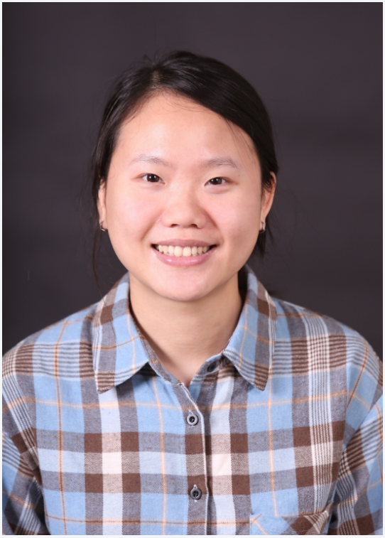 a headshot of Dr. Trang Bui. Her hair is pulled back and she is wearing a blue and brown plaid button-down shirt
