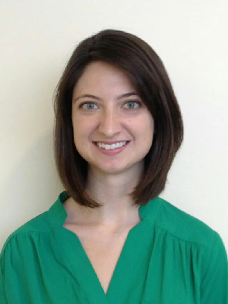 Headshot of Tatum Mortimer with a neutral background.