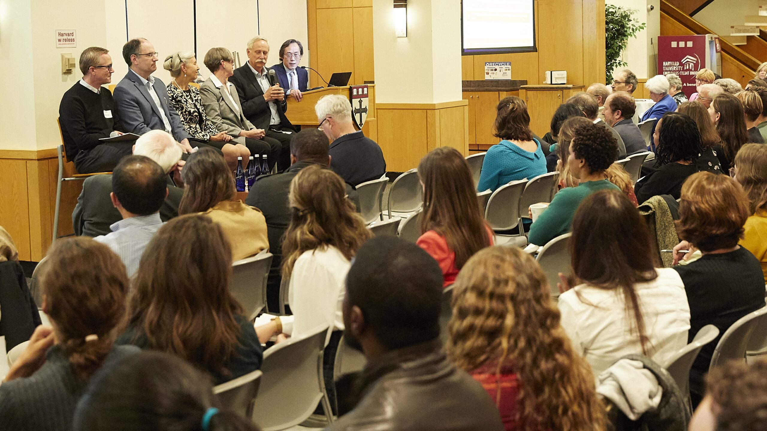 an audience watching a panel of speakers