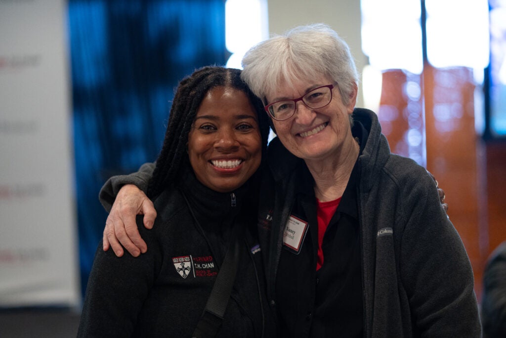 Senior Associate Dean for Educational Programs Nancy Turnbull poses with her arm around a young woman with long braids. Both have big smiles.