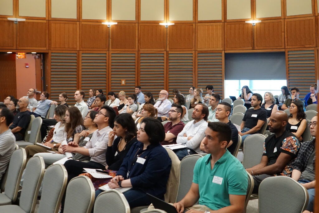 Trainees listen to during the 20th anniversary Symposium at the NRB