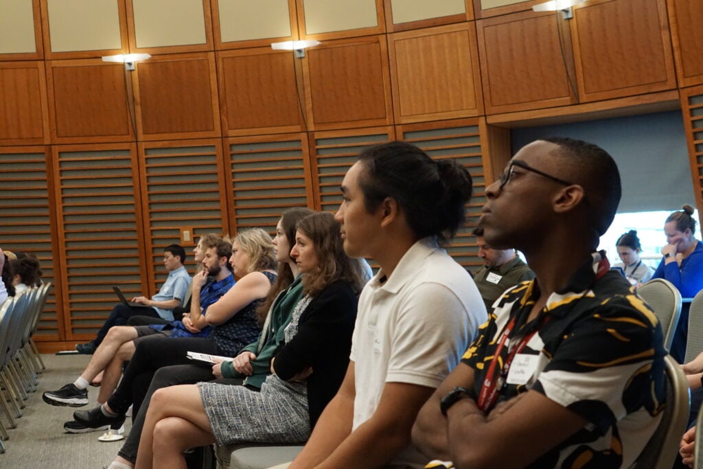 Trainees listen to during the 20th anniversary Symposium at the NRB