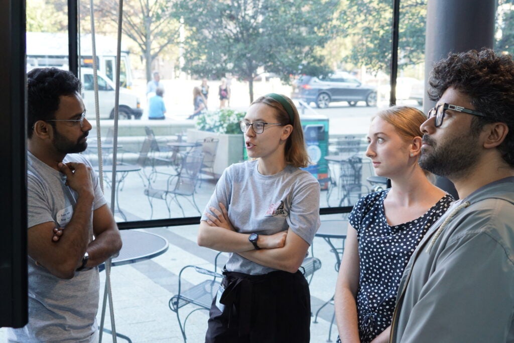 Trainees discuss posters during 20th Anniversary poster session