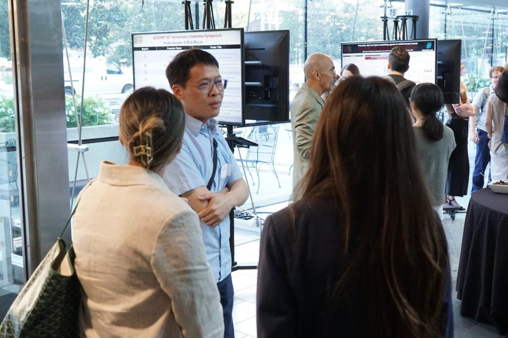 Trainees and PI's discuss posters during 20th Anniversary poster session