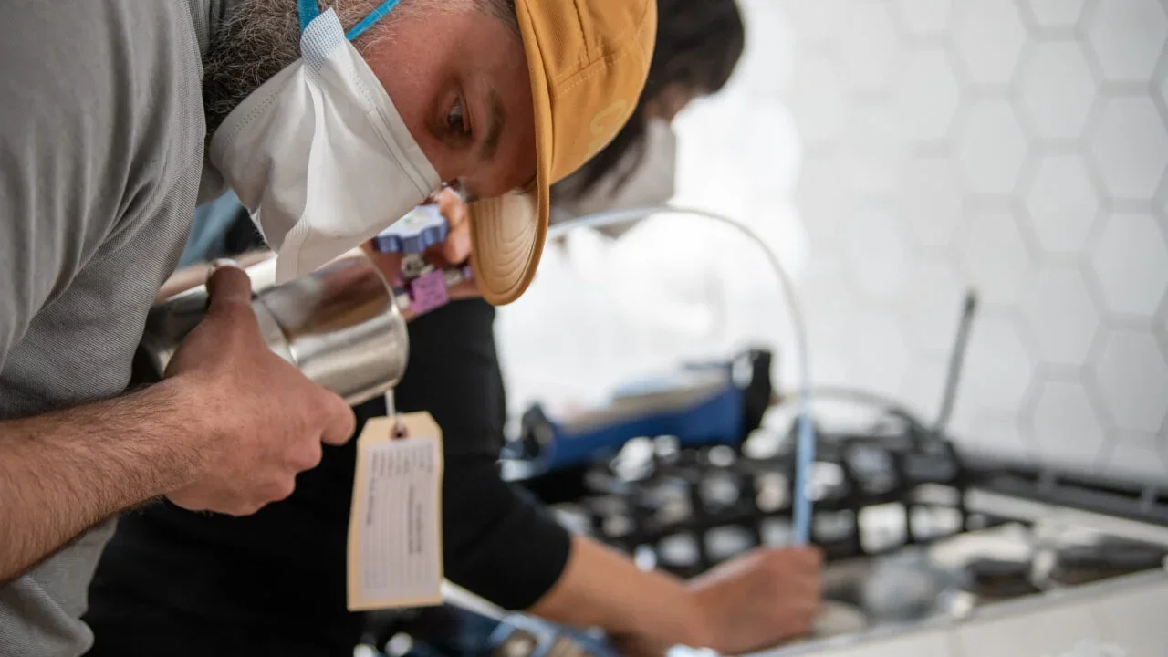 Harvard researcher Drew Michanowicz tests gas coming out of a kitchen stove