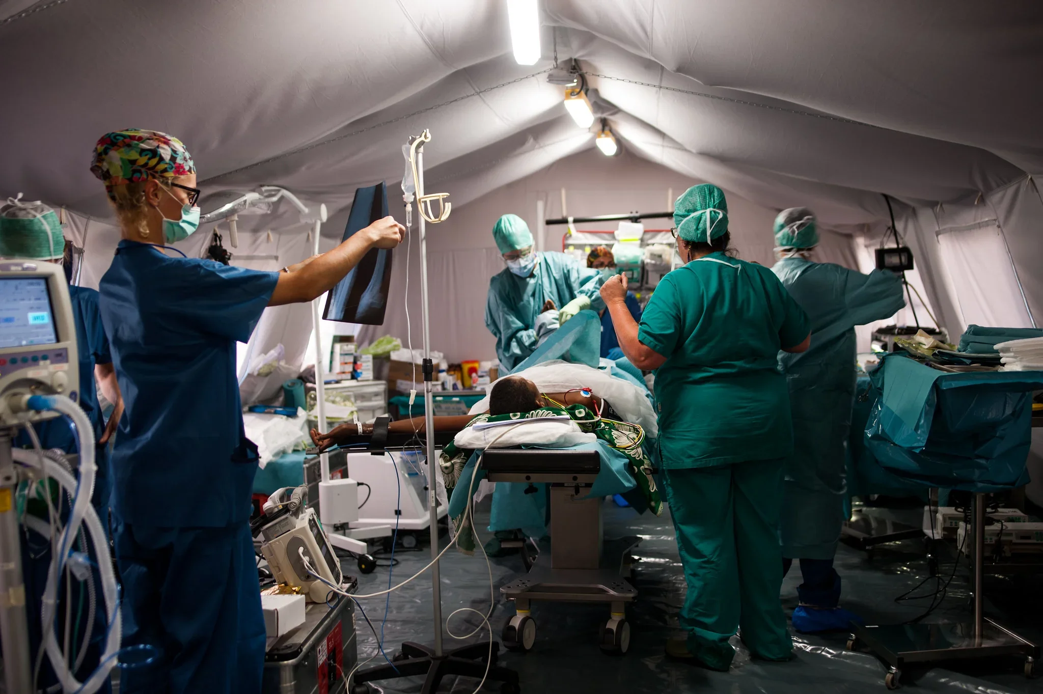 Italian Emergency Medical Team in surgery in a field hospital