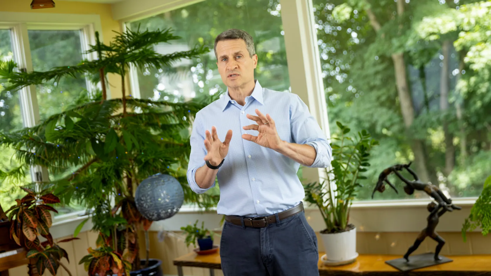 Dr. Roger Shapiro in an office with leafy plants at the Harvard Chan School.