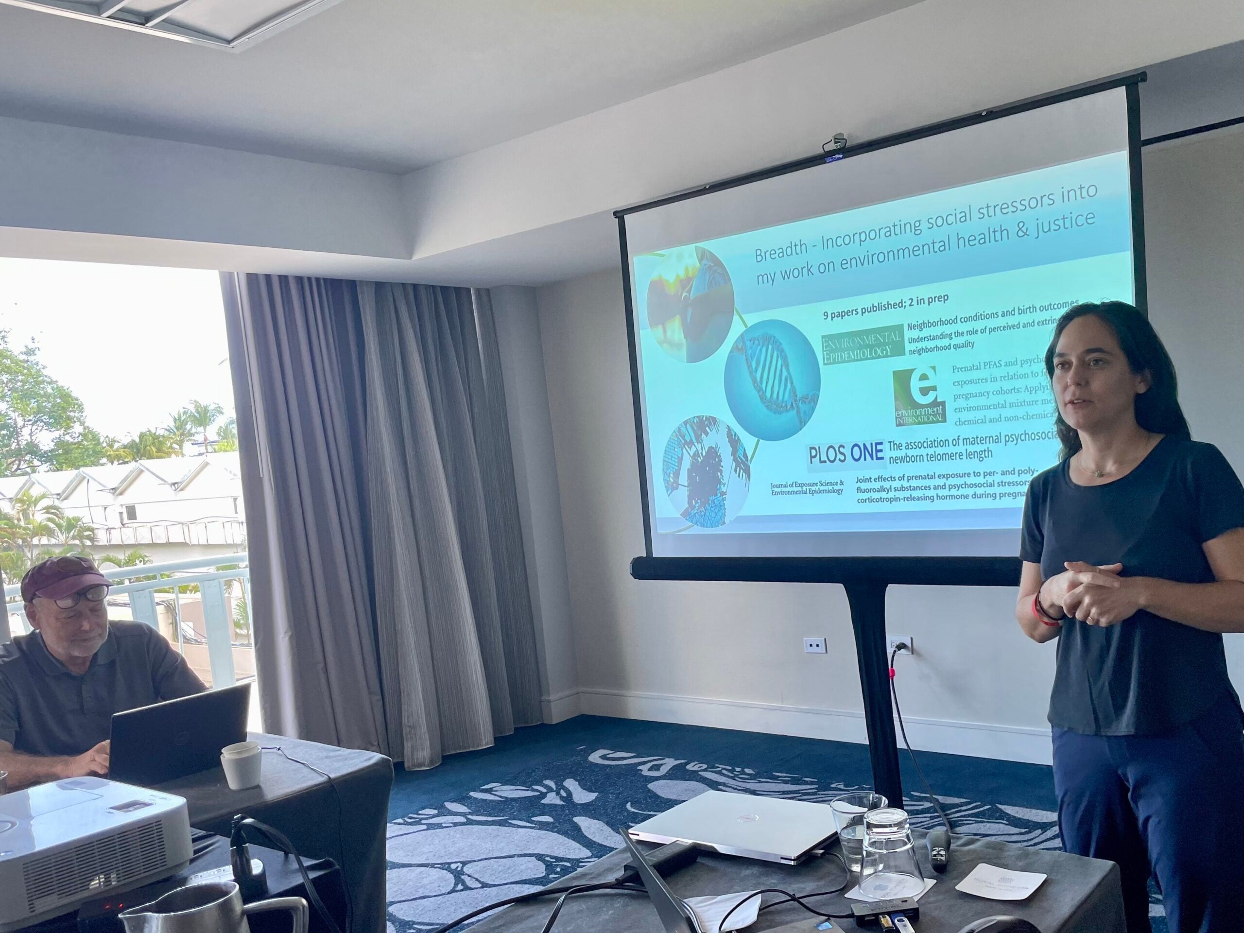 A Fellow presenting their research at a workshop, speaking to an audience.