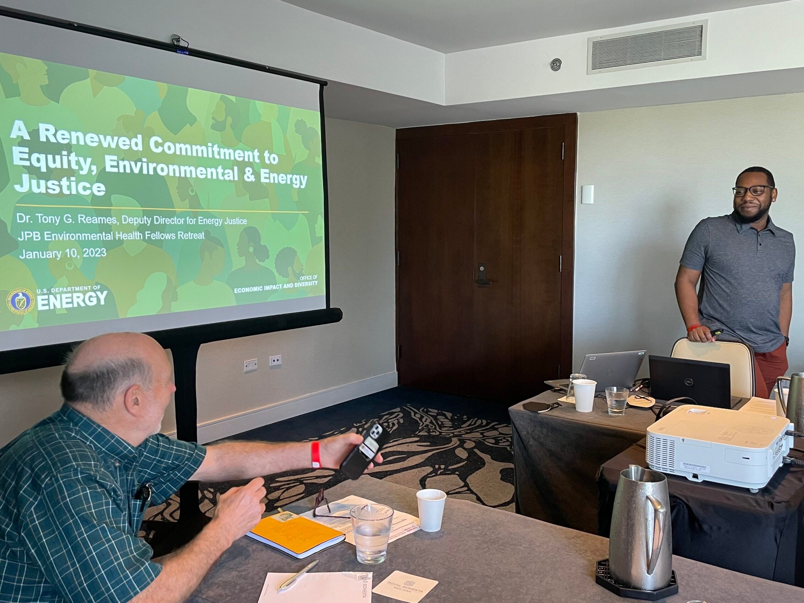 A Fellow presenting their research at a workshop, speaking to an audience.