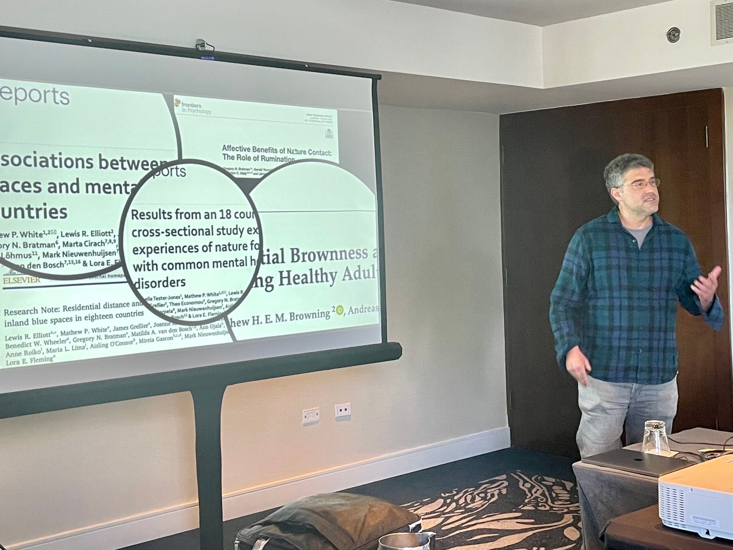 A Fellow presenting their research at a workshop, speaking to an audience.