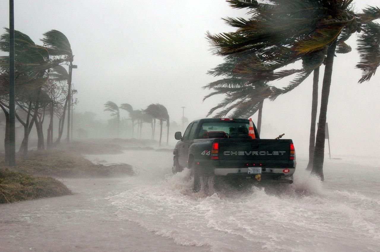 Truck drives through flooded street