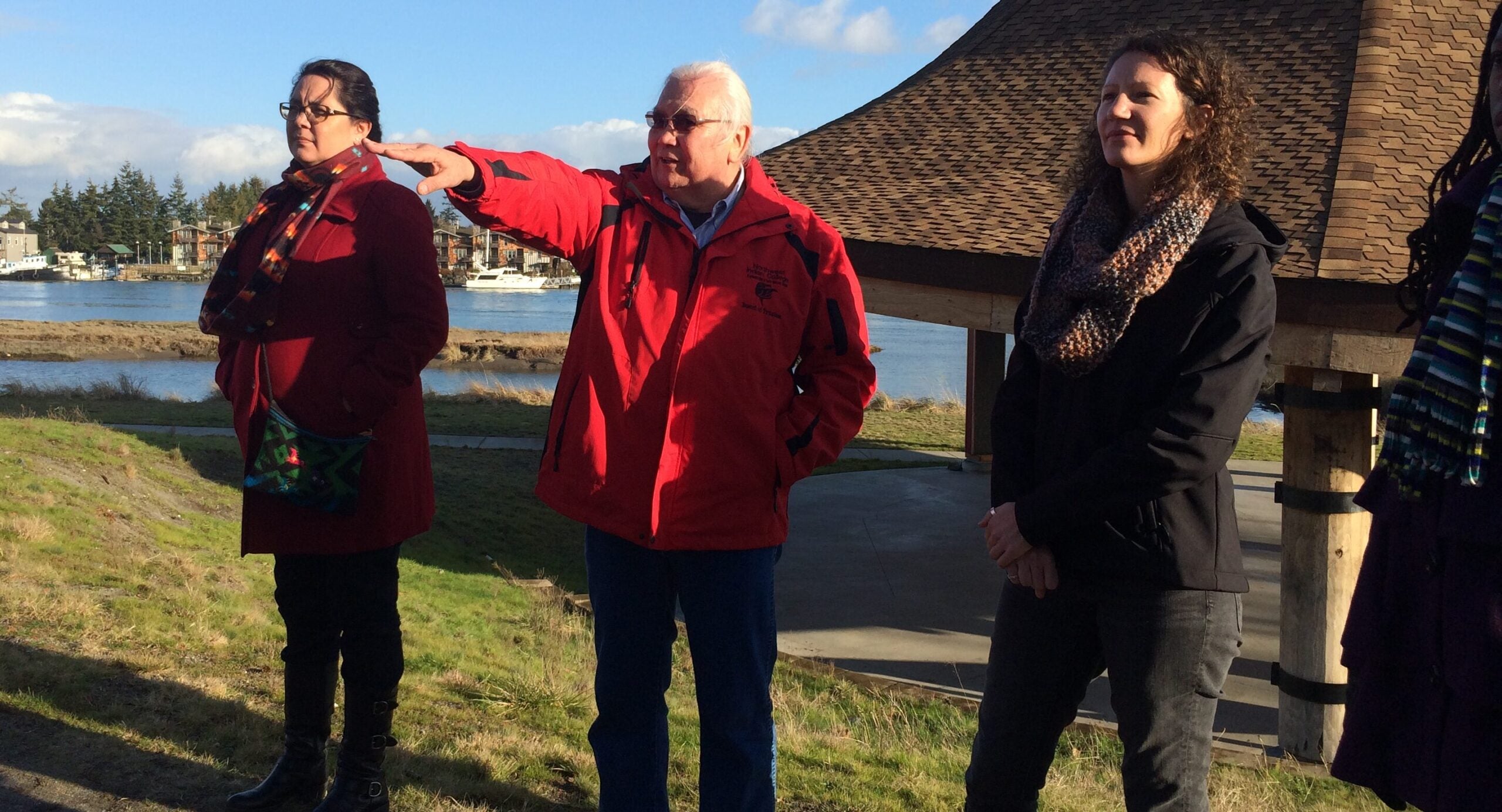 Fellows with a community member during a site visit in Montana, standing together outdoors.