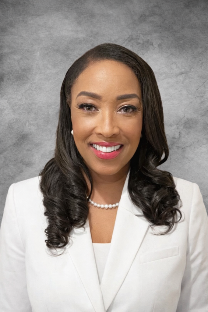 Va Lecia Adams Kellum headshot. woman smiling at the camera wearing a white shirt 