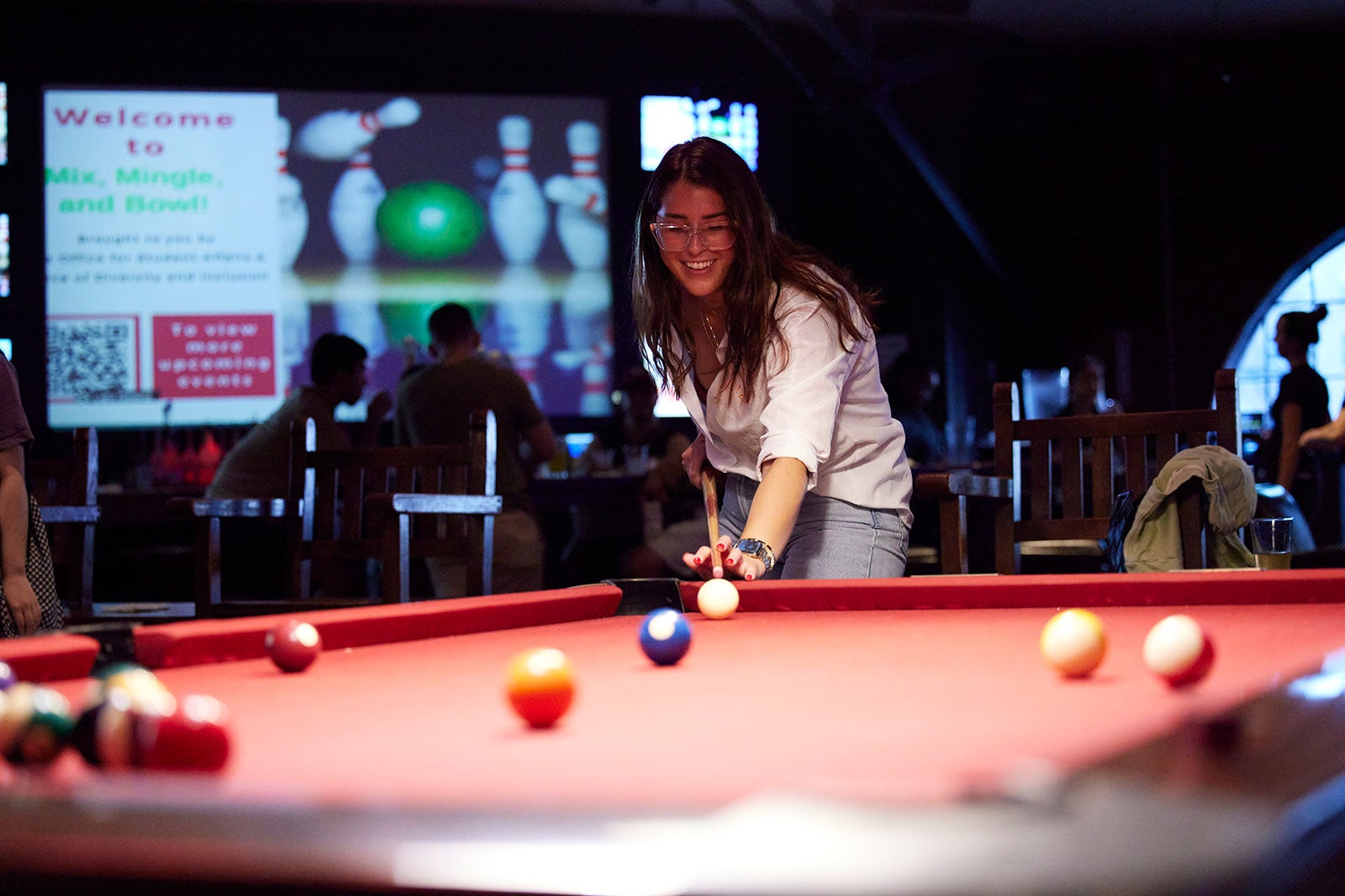 A student plays pool.