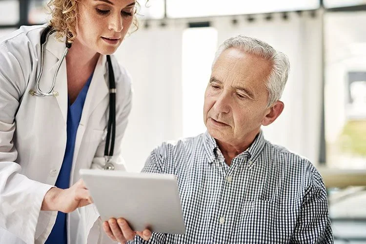 Doctor showing a patient results on a tablet