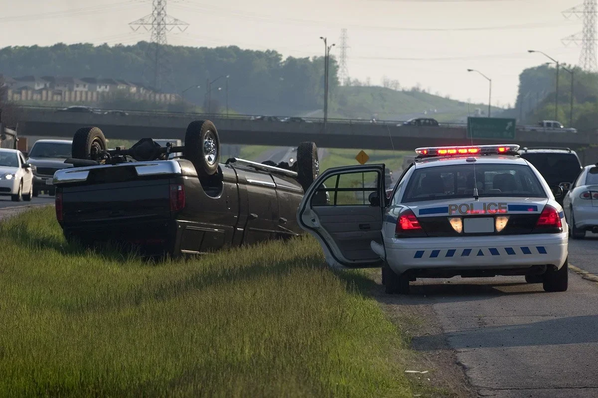 Traffic accident with overturned SUV and police car