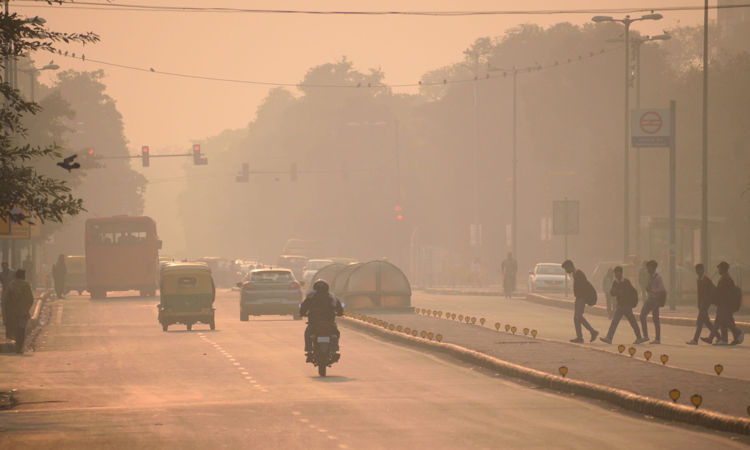 People walking in the streets of Delhi, India amidst smog