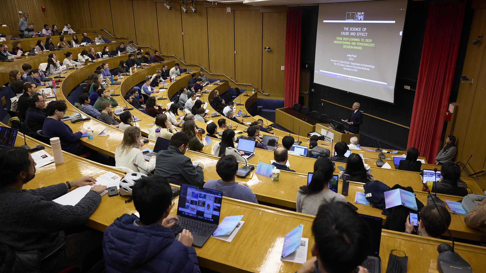 Harvard Chan School's Albert Hofman at the Cutter Lecture, which featured a virtual talk by UCLA's Judea Pearl. Photo shows full house in Harvard Chan School's Snyder Auditorium.