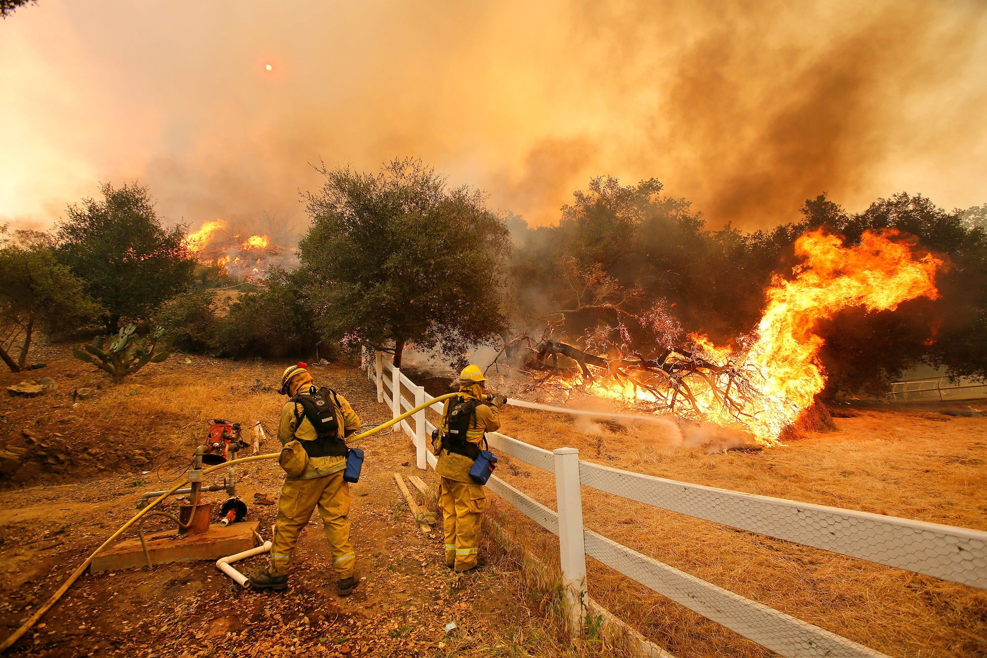 Firefighters from Stockton, CA put out flames off of Hidden Valley Rd. while fighting a wildfire